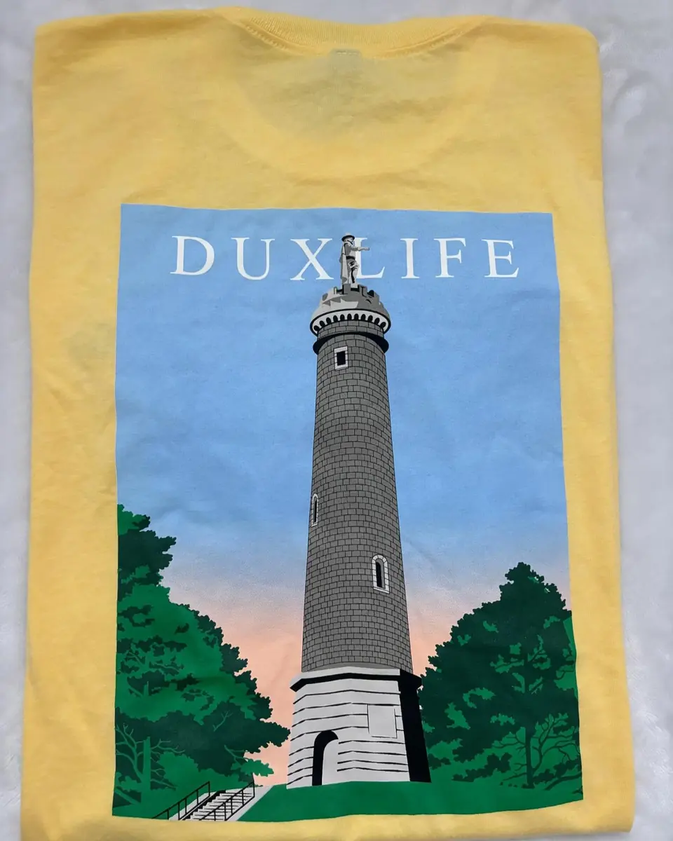 A Duxlife T-shirt with a Duxbury landmark printed on the back