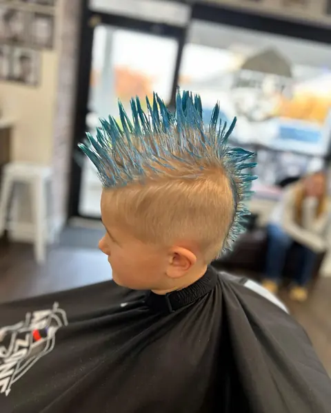 A boy with a spiked blue mohawk for crazy hair day